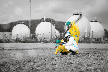 Fototapeta premium Scientists in chemical protective suits are at a water passage, collecting water samples and analyzing data on laptops to monitor pollution and contamination in the industrial area.