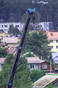A fragment of a telescopic boom of a car crane on a summer day