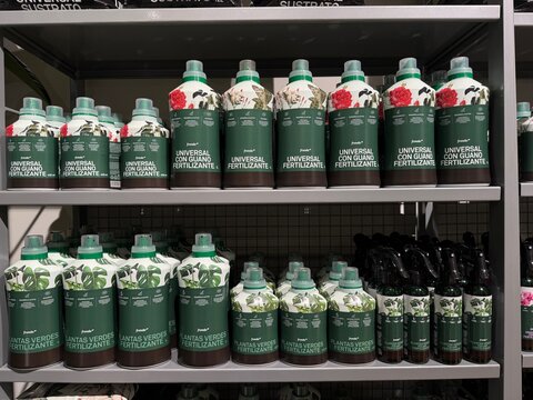 Mallorca, spain, july 06, 2026, fertilizers for plants and universal plant food bottles lining a retail shelf, showing various sizes and labels