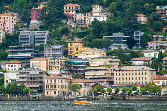 Old houses building architecture on lake Como, Italy. Italian village Cityscape with Colorful houses architecture on a Green Hill.