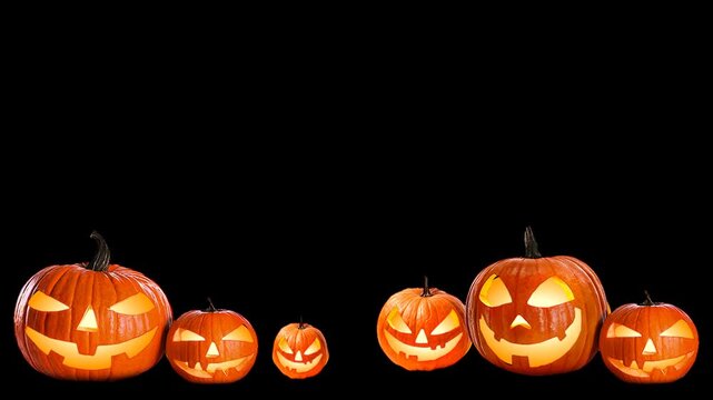 Seamless Halloween black background with glowing carved orange Jack-o'-lantern pumpkins in a row with copy space