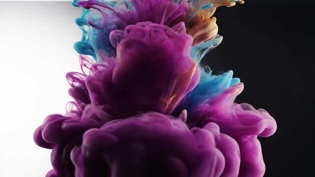 Colorful ink clouds mixing in water with purple and blue tones on a dual tone background