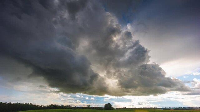 Storm clouds moving in a Timelapse. Summer storm with cumulus clouds and rain