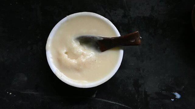 pure desi ghee in wooden bowl on black background