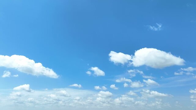 Sideward aerial drone movement capturing vibrant blue skies and floating clouds, reflecting optimism, discovery, adventure, future possibilities, personal growth, and the pursuit of new opportunities.