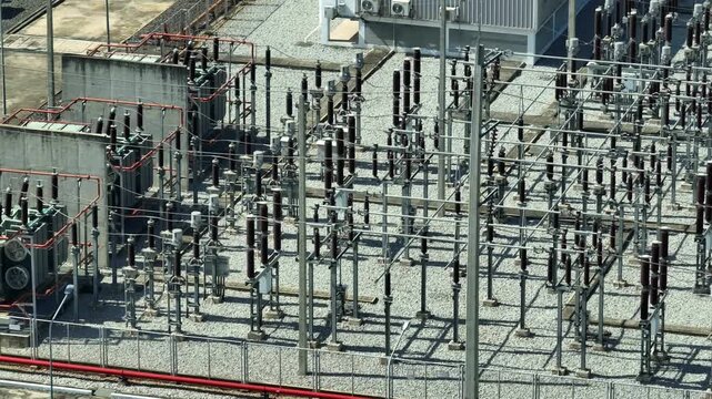 Overhead drone shot of an electrical substation, representing advanced power grid infrastructure, system integration, energy reliability, and secure electricity transmission for modern industries. 4k.