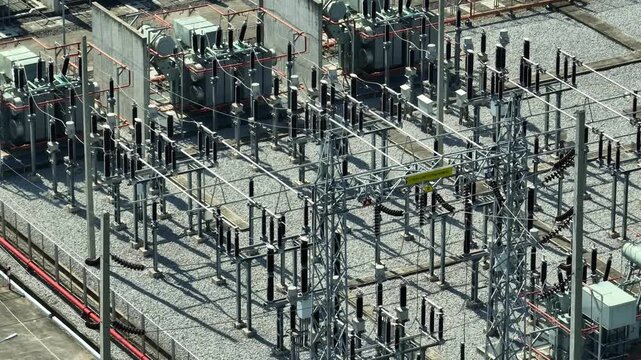 Drone aerial view of a high-voltage substation with transformers and switchgear, highlighting grid modernization, resilient utility systems, and stable electricity distribution for communities.
