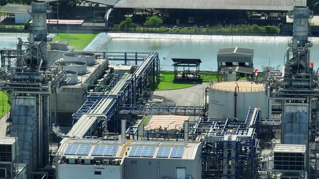 Overhead drone shot of a combined cycle power plant with integrated facilities, symbolizing ESG-driven modernization, lower-carbon energy production, grid reliability, and advanced engineering. 4k.
