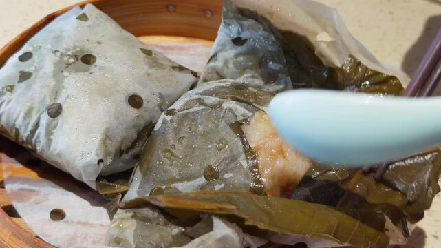Cantonese Lo Mai Gai Lotus Leaf Sticky Rice Chicken Unwrapped Chopsticks Lifting