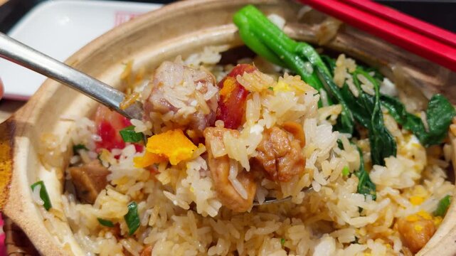 Guangzhou Clay Pot Rice Mixed with Toppings Spoon Lifting Close-Up