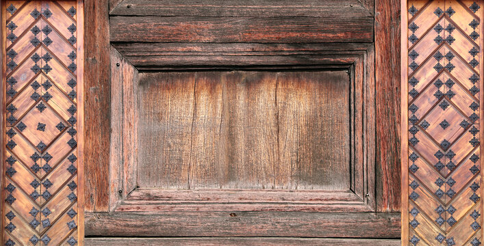 Texture of vintage wood board with decorative border with metal rivets. Vertical or horizontal retro background with old wooden plank and aged iron reinforcement. Copy space for text. Mock up template