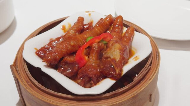 Cantonese Dim Sum Chicken Feet in Bamboo Steamer Handheld Slow Pan Shot