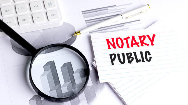 Notary public concept with legal documents magnifying glass calculator and business charts representing document