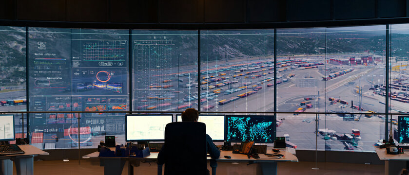 logistics coordinators monitoring abstract shipment flow dashboards without readable text, balanced lighting