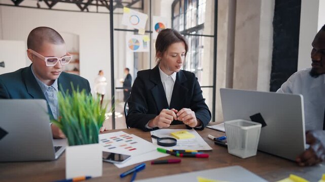 Work in marketing department of big company, young adult people discussing ideas . Woman boss giving tasks to employees, diverse people working together in international company, financial analysts