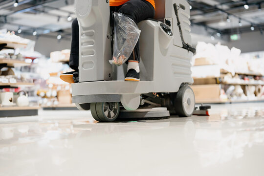worker cleaning floor with machine	