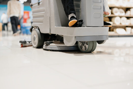 worker cleaning floor with machine	