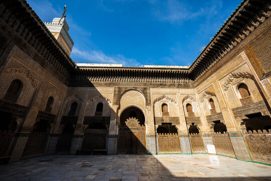 Ancient Moroccan madrasa courtyard on a sunny day