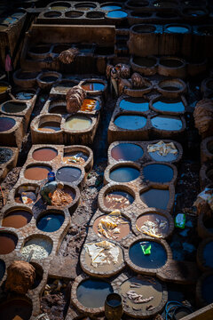 Men working in historic Moroccan leather dye pits