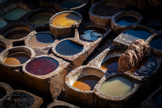 Overhead view of ancient stone vats in Fes Morocco tannery