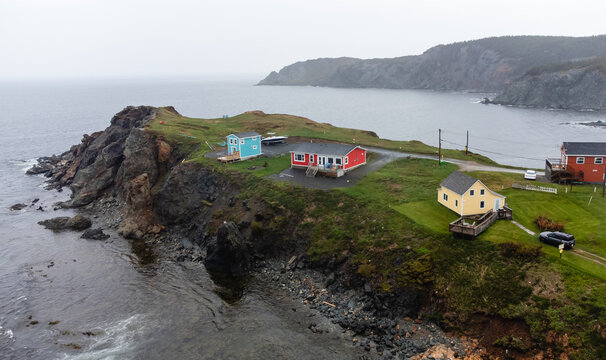 Colorful houses on a rocky Newfoundland coast on cloudy day