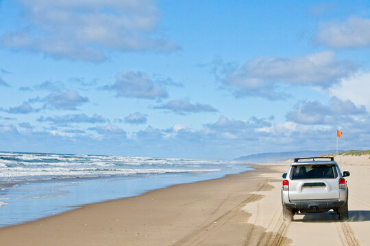 Off roading in a silver SUV along the coast