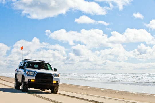 SUV off roading along the ocean shoreline