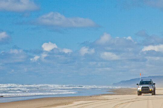 Off road truck driving on a sandy beach