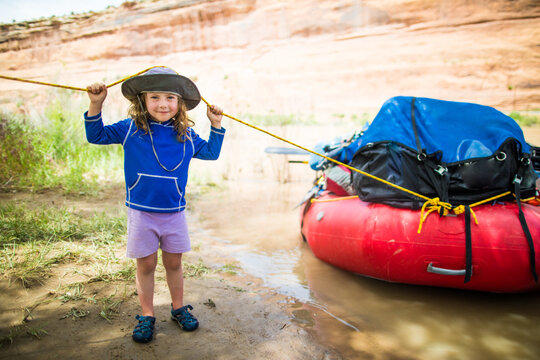 Young girl pulling a river raft ashore