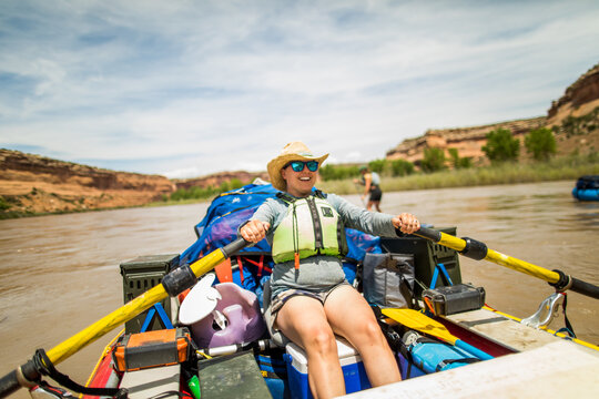Smiling woman rafting on a desert river