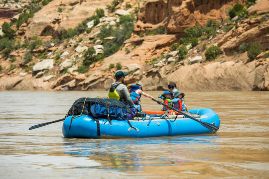 Young family with kids on a river raft adventure