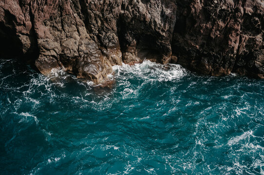 Dramatic ocean waves against a rocky coastline