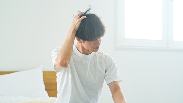 頭をかく男性。ふけ、かゆみ、寝坊、疲労、悩み、寝癖、寝起き、ボディケア、ヘアケア、パーマ、頭皮、起床