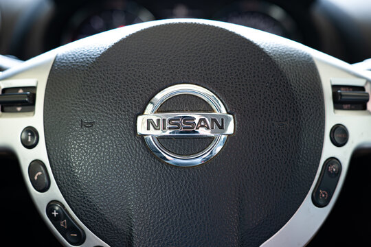 Arad, Romania, June 18, 2026. Close up shot of the chrome Nissan logo emblem on the steering wheel inside a car