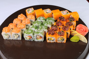 Assorted Sushi Rolls Platter on Dark Plate © polakravis