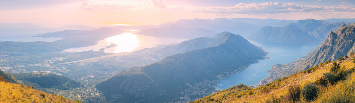 Adriatic Sea panorama with sunset reflecting on water, overlooking the historic towns, coastline, and surrounding mountains in Montenegro