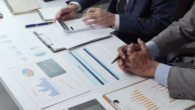Businessmen analyzing financial report data in meeting