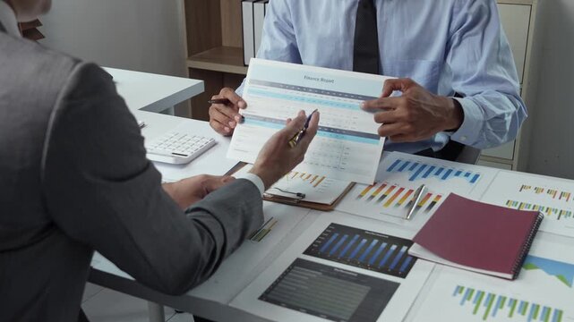 Businessmen analyzing a financial report during a meeting