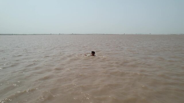 drowing man in river ariel view