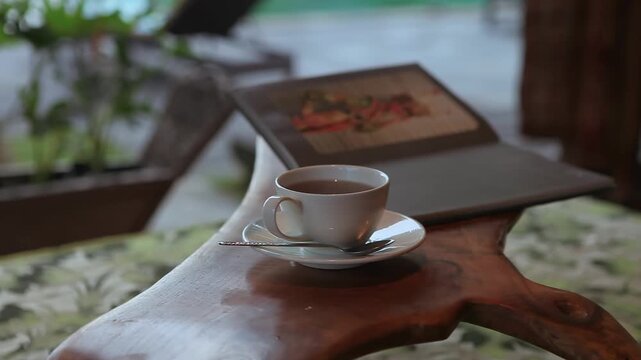 Hot Tea Cup on a Luxury Wooden Table at Bali Resort Lounge