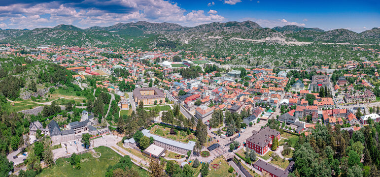 Cetinje historic city, Montenegro, featuring its famous monastery, National Museum, and surrounding mountains under a blue sky