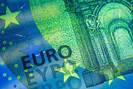 Euro banknote showing security features under ultraviolet light.