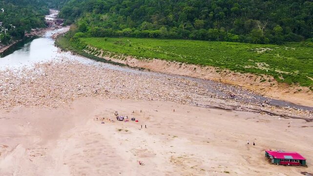 Drone pullback of Piyain river at Bichanakandi, Sylhet, exposed riverbed, stone deposits and sand extraction.