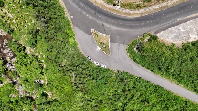 Drone footage captured from a top-down perspective while descending near Mui Dien Lighthouse in Vietnam.