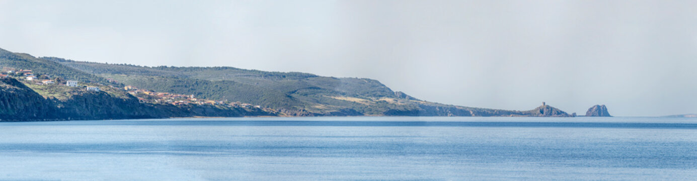 Sa Mora tower on Mannu cape and Mal di Ventre island on Mediterranean shore, from Bosa Marina, Oristano, Italy