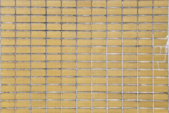 Vintage Yellow Tile Wall Texture with Grunge Detail and Dramatic Cinematic Lighting.