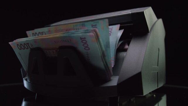 Ukrainian Hryvnia Banknotes in Money Counting Machine