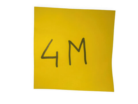 Yellow sticky note with 4M written on it in black marker