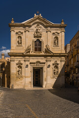 Fototapeta premium Charming historic streets and architecture of Taranto old town (Citta Vecchia) in Puglia, Italy. Featuring ancient stone buildings, narrow alleys, and rich heritage.