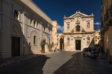 Fototapeta premium Charming historic streets and architecture of Taranto old town (Citta Vecchia) in Puglia, Italy. Featuring ancient stone buildings, narrow alleys, and rich heritage.